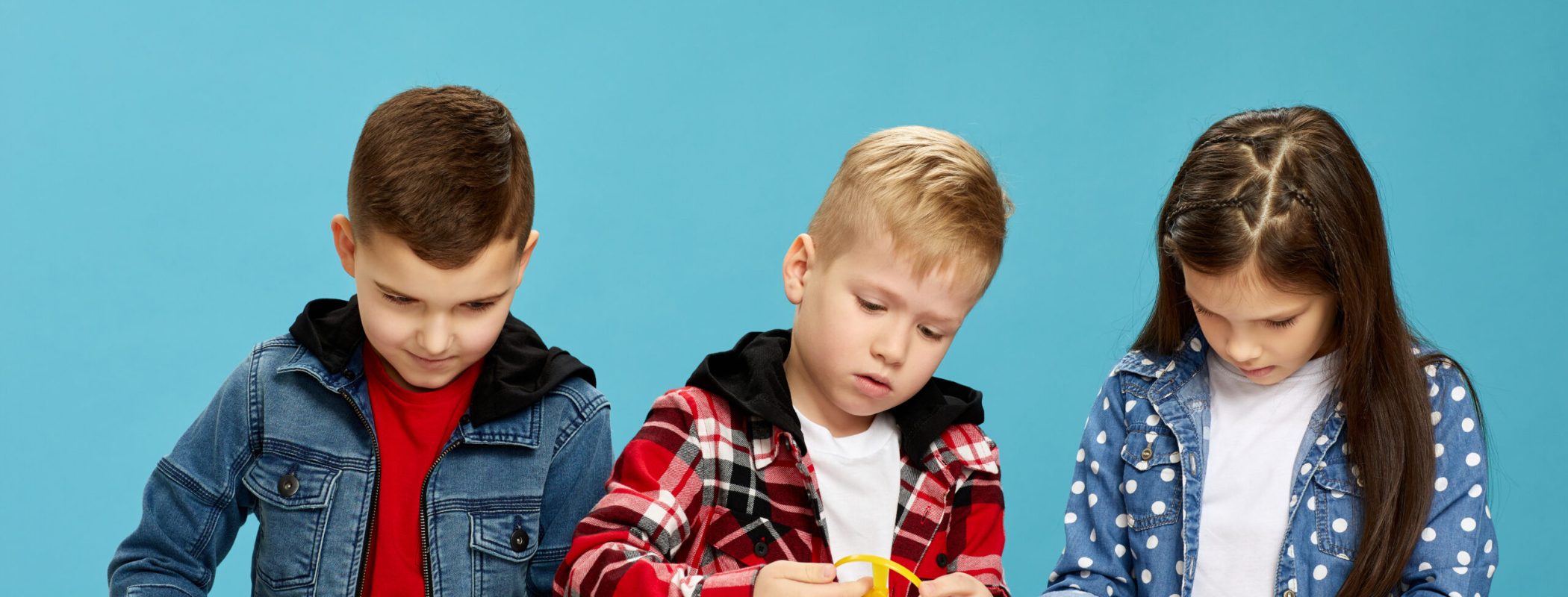 cute children assemble electronic constructor on desk. Children learn.