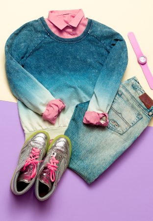 Fashion woman accessories set. Vanilla Lady. jeans, Sweater and shirt hipster trendy girl. creative look. Vanilla and blue pastel background, fashion sneakers and watches